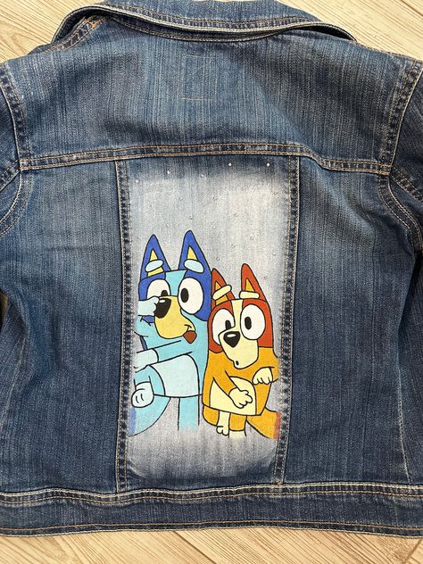 Your kiddo will be the coolest kid with this awesome Bluey jean jacket. Hand painted design and rhinestones to make it shine on the back and front. This item is ready to ship.  Jacket can be shipped in 1-2 business days. No refunds or exchanges Jean Jacket Painted, Hand Painted Jean Jacket, Jacket Hand Painted, Painting Clothes, Kids Jeans Jacket, Custom Jean Jacket, Painted Clothes Diy, Painted Jacket, Tattoos Women