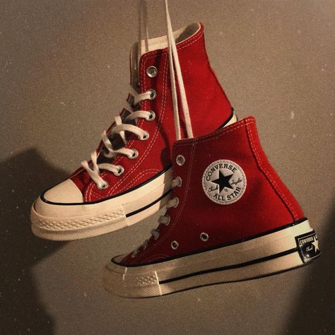 A pair of enamel red Converse Chuck 70 shoes held in the air by its laces with a grungy filter edited to bring a 90s worn out aesthetic. Red Converse Aesthetic, Dark Red Converse, Converse Chuck 70s, Converse 70s, Chuck 70s, Converse Aesthetic, Aesthetic Ig, Red Converse, Converse Chuck 70