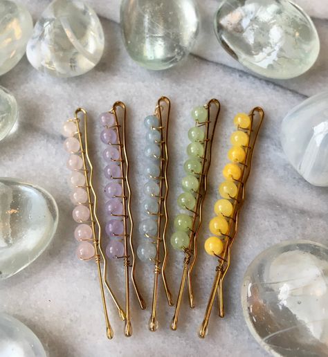 Rose quartz, violet jadeite, angelite, chalcedony and yellow jade, natural crystal/stone beads on gold colored 2.3 inch metal alloy hair pins. You get a set of 5 pins, one of each color.