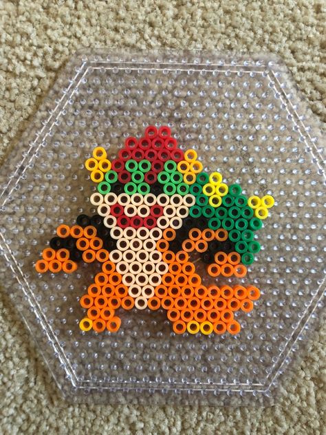 Super Mario Bowser villain perler bead craft design Perler Beads Disney Villains, Mario Melty Bead Patterns, Mario Characters Perler Beads, King Boo Perler Beads, Mario Melty Beads, Perler Bead Bowser, Perler Designs Ideas, Nerd Perler Bead Patterns, Bowser Perler Beads