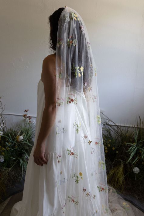 The Fleur Pastel Floral Wedding Veil is a unique, etherial wedding veil that will instantly make a statement. 

This awe-inspiring embroidered veil is made from lightweight, fine-grade tulle that has been delicately accented by an array of embroidered pastel floral motifs. The result is a sophisticated yet bohemian bridal veil that will add a pop of color and enchantment to any simple bridal gown. Wildflower Veil, Pastel Floral Wedding, Floral Wedding Veil, Unique Wedding Veils, Floral Wedding Veils, Embroidered Veil, Fingertip Length Veil, Boho Veils, Veil Floral