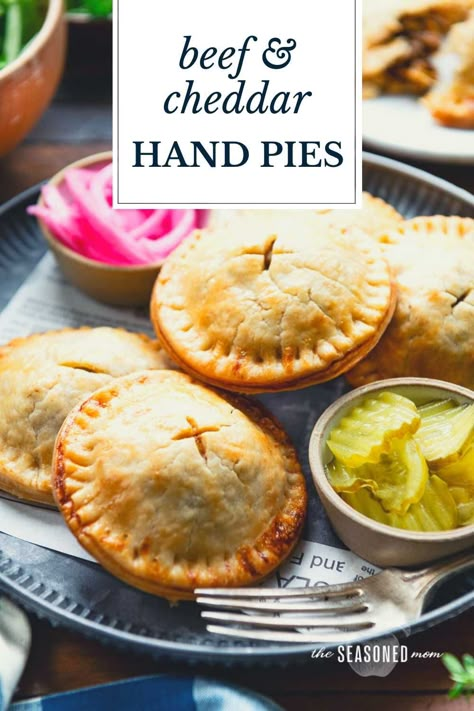 These easy meat pies include tender, buttery, flaky pastry dough wrapped around a flavorful ground beef, cheddar, and caramelized onion filling. Thanks to a couple of shortcuts, the convenient savory hand pies come together quickly and can be assembled in advance for busy weeknights! Easy Meat Pies, Savory Hand Pies Recipes, Savory Hand Pies, Beef And Cheddar, Hand Pies Savory, Beef Pot Pies, Meat Pie Recipe, Beef Pies, Hand Pie Recipes