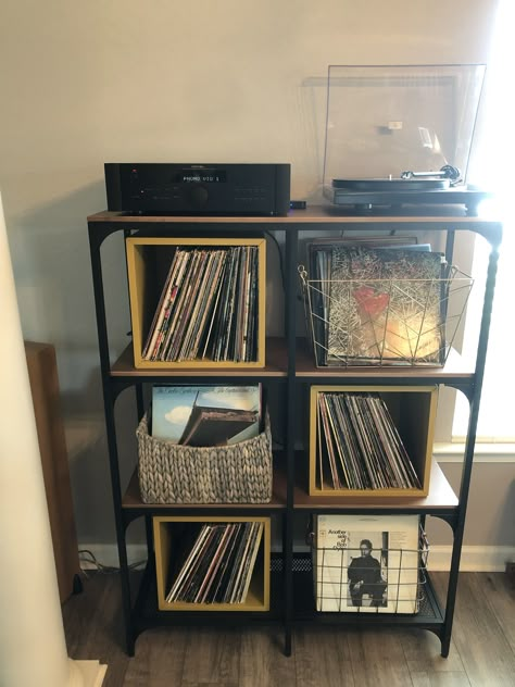 I finally found a good solution to storing our hundreds of records. The shelf unit was on sale for $79 at Ikea (Fjällbo). The mustard boxes are also from Ikea (Eket) at $20 each and the baskets were found at Home Goods for $10 each. Total cost of the project was $160. My husband and I are tall (5’9” +) so the height of the record player works but if you’re shorter, it may be too tall. I couldn’t be happier with how it turned out. Ikea Eket Record Storage, Fjallbo Ikea Living Room, Ikea Fjallbo Ideas, Fjallbo Ikea Hack, Fjallbo Ikea, Ikea Fjallbo, Fjällbo Ikea, Record Storage Ideas, Ikea Eket