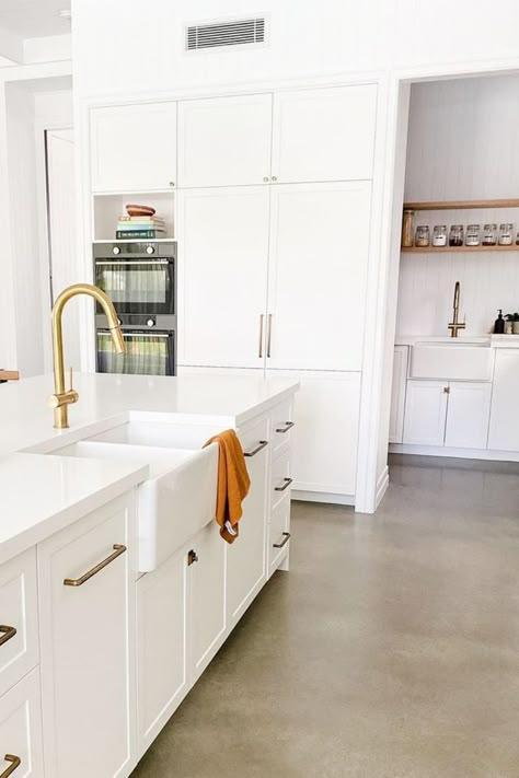 Modern kitchen with white cabinetry and polished concrete floors. Featured is also a butlers pantry with matching tapware and sink. Polished Concrete Floor Kitchen, Concrete Floor Kitchen, Kitchen Concrete Floor, Concrete Kitchen Floor, Polished Concrete Kitchen, Concrete Tile Floor, White Kitchen Appliances, White Cupboards, White Shaker Kitchen