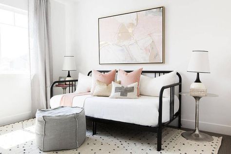 Pink and black guest room features a pink and gold abstract art piece placed over a black daybed dressed in blush pink pillows as well as a gold metallic pillow flanked by round silver nightstands topped with black and white rugs. Guest Room Daybed, Girl Horse Room, Black Daybed, Daybed Room, Guest Bedroom/office, Guest Room Design, Office Guest Room, Guest Room Office, Plywood Furniture