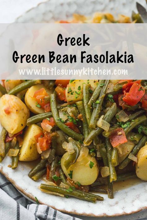 Healthy Greek green beans braised in extra virgin olive oil with tomato and potatoes. This simple and easy vegan recipe makes a wonderful entre that takes just half an hour to make. #fasolakia #greenbeanrecipe #greekfood #greekgreenbeans Greek Green Beans And Potatoes, Fasolakia Recipe Crockpot, Greek Vegetable Recipes, Greek Fasolakia, Greek Green Beans With Tomatoes, Fasolakia Recipe, Greek Beans, Mediterranean Plate, Easy Greek Recipes