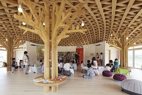 Conceived as a large straw sun hat held aloft by trees this building is an indoor play space for children between the ages of 0-4 . These spaces are important due to the ongoing concerns about background radiation levels. As the children cannot play outside, we felt the building should feel like you are playing in a forrest with trees. The cross laminated timber columns help reduce the span of the timber roof making it lighter and have been designed to resemble trees – complete with their ... Community Hall, Temporary Housing, Indoor Play Areas, Big Tents, Timber Roof, Community Halls, Japanese Architect, Column Design, Community Space