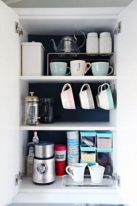 It's amazing what a difference some dark paint makes when trying to find items. Plus, hooks attached to the bottom of a shelf allows mugs to hang, while dividers create shorter shelves for even more coffee cups. See more at I Heart Organizing »   - HouseBeautiful.com Coffee Cabinet, Mug Storage, Kitchen Organization Diy, Organisation Hacks, Kitchen Hacks Organization, Kitchen Storage Solutions, Kitchen Cabinet Organization, Declutter Your Home, Cabinets Organization