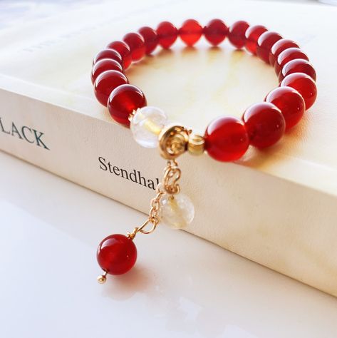 "Thank you for your interest in this gorgeous agate crystal bead bracelet. = = = = = = = = = = ♥. Product facts: - Natural beaded gemstones/crystal; - Adjustable elastic cord for standard wrist sizes; - Agate is an excellent stone for rebalancing and harmonizing body, mind and spirit； - This white crystal is considered a \"master healer\" and it's said to amplify energy by absorbing, storing, releasing, and regulating it; - Detachable charm; - Gold plated details; - For reference, the diameter o Red Agate Bracelet, Crystal Bead Bracelet, Crystal Beads Bracelet, Bracelet Women, Agate Bracelet, Pretty Bracelets, Red Agate, Agate Crystal, Bracelet Charm