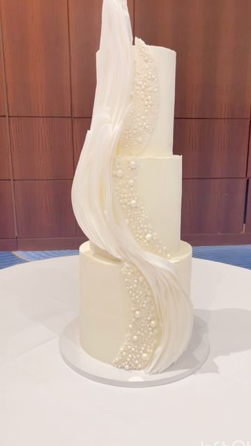 Dinika S Johnson• Wedding & Custom Cake Designer on Instagram: "• P E A R L + W A F E R P A P E R • 
.
.
.
.
.
.
.
.
This was the first time I’ve done structured pearls on a cake. The end result was a textured beauty with waves of wafer paper. 🤍
 
.
.
.
.
.
.
.
.#weddingcakes #atlantaweddings #atlantawedding #atlantaweddingcakes #atlantacake #atlantacakes  #atlantacakeartist #atlantaweddingcakebaker #atlantaevents #atlantaevent #whiteweddingcake #pearlcake #atlantabridal #waferpapercake #Weddingcake #weddingcakes #atlantaweddings #atlantawedding #atlantaweddingcakes #atlantacake #atlantacakes  #atlantacakeartist #atlantaweddingcakebaker #atlantaevents #atlantaevent #whiteweddingcake #atlantaweddingplanner #contemporarycakes #atlantabridal #cakedesign #atlantabrides #atlantaweddingvendors Pearls Wedding Cake, Pearl Cake Wedding, Modern Wedding Cake Designs, Wedding Cake Pearls, Pearl Cake, Wafer Paper Cake, Modern Wedding Cake, White Wedding Cake, Wafer Paper