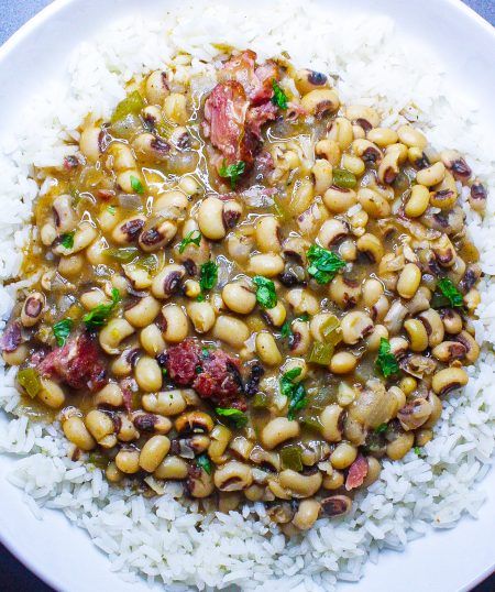 Creole Black-Eyed Peas | Tony Chachere's Black Eyed Peas And Rice, Creole Dishes, Peas And Rice, Black Eyed Peas Recipe, Smoked Turkey Legs, Creole Cooking, Sauteed Greens, Cooking Bacon, Rice And Peas