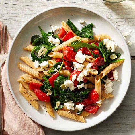 In this quick 20-minute dinner recipe, tender penne pasta is combined with garlic, roasted red peppers and spinach and topped with crumbled feta cheese for a fast and easy Mediterranean-inspired meal. This recipe was graciously shared by EatingWell reader Dottie Carpenter, who states, "Recipes are no good if they're not shared!" Pasta Spinach, Penne Pasta Recipes, Pasta With Spinach, 20 Minute Dinners, Mediterranean Pasta, Spinach Feta, Broccoli Pasta, Feta Pasta, Pasta Dinners