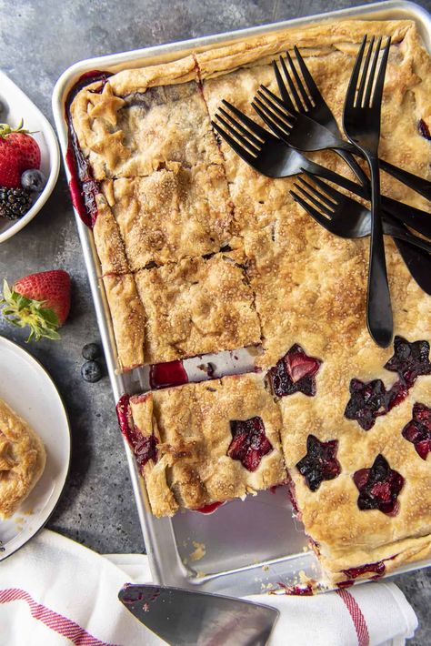 This Triple Berry Slab Pie, made with fresh strawberries, blueberries, and blackberries, is a delicious way to feed a crowd at any backyard cookout, block party, or potluck! The super flaky all-butter crust is the star of the show, but the gooey berry filling shines with every bite! Blueberry Slab Pie, Berry Slab Pie, Slab Pies, Berry Filling, Triple Berry Pie, Slab Pie Recipes, Homemade Pie Recipes, Favorite Pie Recipes, Butter Crust