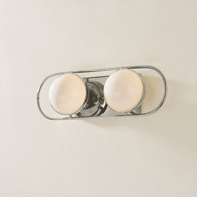 Opal glass spheres are held in gem-like settings, bringing a modern jewelry aesthetic to the bath or powder room. The two-, three-, and four-light options are displayed within an elegant metal racetrack frame and can be mounted vertically or horizontally making them perfect solo above a mirror or in pairs alongside it. Finish: Polished Nickel | Hudson Valley Lighting Amy 2 Light Bath & Vanity 5.5 H x 16.0 W x 5.25 D in gray in Polished Nickel | 5.5" H X 16" W X 5.25" D | Wayfair Bathroom Lighting Next To Mirror, Mid Century Bathroom Light, Vintage Vanity Light, Chrome Fixtures Bathroom, Polished Nickel Bathroom Fixtures, Above Mirror Bathroom Lighting, Nickel Mirror, Polished Nickel Bathroom, Jewellery Aesthetic