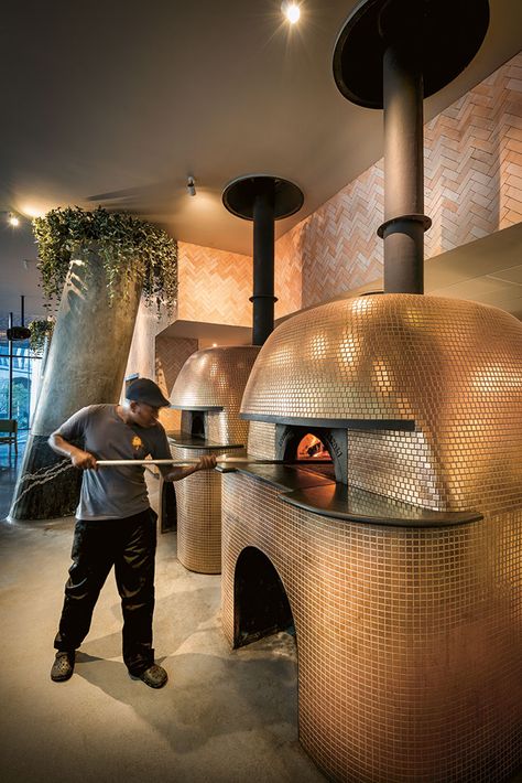 Two gigantic imported Stefano Ferrara pizza ovens, widely considered the Rolls-Royce of pizza ovens, are open to the restaurant. They have been clad ingold mosaics to add a theatrical aspectto the experience of dining at Saint. Pizza Oven Bar, Pizza Oven Restaurant Design, Wood Fired Pizza Oven Restaurant, Pizza Oven Mosaic, Wood Fired Pizza Restaurant, Pizza Restaurant Design, Pizza Oven Restaurant, Pizza Oven Design, Indoor Pizza Oven