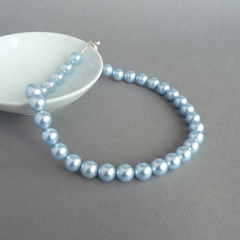 This chunky light blue pearl necklace has been created using lustrous Swarovski pearls. The luxurious pale blue Swarovski pearls give this piece an opulent feel making it perfect for weddings or special occasions.  Each baby blue pearl measures 12mm in diameter. This single pearl strand necklace measures 46.4cm (18.25 inches) from end to end and is finished with a sterling silver toggle clasp. Beads are strung on 49 strands of stainless steel wire for strength.  Swarovski pearls are known worldw Baby Blue Jewelry, Pearl Jewellery Set, Blue Pearl Necklace, Chunky Stone Necklace, Big Pearl Necklace, Pale Blue Wedding, Light Blue Necklace, Strength Bracelet, Blue Jewelry Set