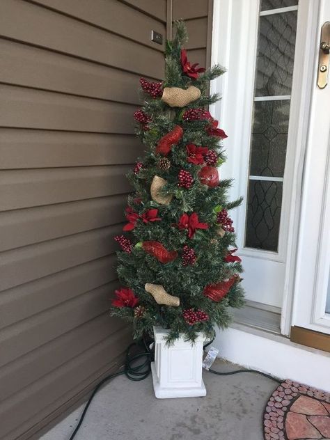 For about 4 yrs on our front porch I have had a potted artificial tree I bought from Menards. It's in a solid heavy white base, lights up but every year it just seems like it looks worse and worse. Lite up it was fine but during the day, blah...So, after a week in Mexico i came home and started to get Christmas decorations out. In comes the dollar store... it just amazes me what you can find there.i bought $5 worth of items at the dollar store and perfect tree... What it looked l… Dollar Store Christmas Tree, Store Christmas Tree, Dollar Store Decorations, Porch Christmas Tree, Faux Christmas Tree, Rustic Chic Christmas, Decorations On A Budget, Faux Christmas Trees, Faux Christmas