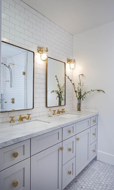 Well appointed light gray and white basement bathroom features two Restoration Hardware Bristol Flat Mirrors mounted on white subway backsplash tiles and illuminated by brass cage wall sconces. Diy Home Decor For Apartments, Bad Inspiration, Home Luxury, Basement Bathroom, Trendy Bathroom, Girls Bathroom, White Rooms, Bath Room, Marble Bathroom