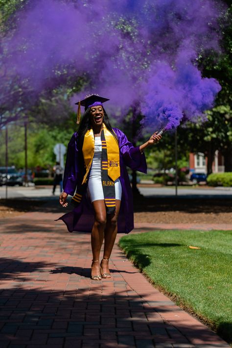 Our first time using smoke bombs... Ever! Believe it or not, it took us only one shot to get it right.    #essence #trueessencephotography #photography #photography #sonyshooter #blackisbeautiful #black #gold #purple #ecu #eastcarolina #fountain #water #patience #smile #beautiful #gown #capandgown #cap #tassel #outside #beforecovid #dress #smoke #smokebomb Purple Graduation Outfit, Graduation Fountain Pics, Purple Senior Pictures, Black Graduation, Purple Cap And Gown Graduation Outfit, Purple Graduation, Ecu Graduation Pictures, Blue Cap And Gown Graduation Outfit, Purple Graduation Gown