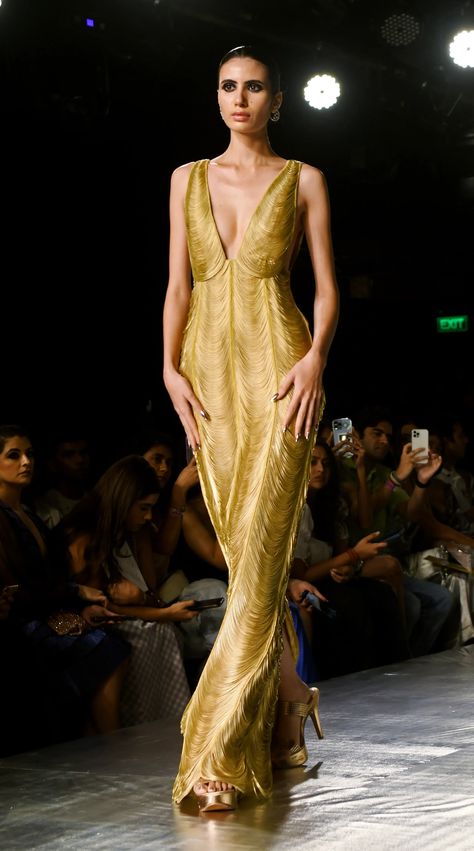 Rimzim Dadu's debut collection included a stunning floor-length gown, resembling wearable liquid gold. Luxury Bollywood Gown With Gold Embroidery, Couture Week 2023, Luxury Gold Gown With Intricate Embroidery, Rimzim Dadu, Gold Haute Couture Gowns, Annie Core, Gold Runway Dress, Golden Runway Dress, Structured Gown