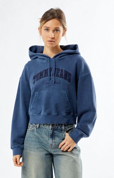 The Garment Dye Varsity Boxy Cropped Hoodie from Tommy Jeans blends sporty vibes with everyday comfort. Featuring a garment-dyed wash, this hoodie is designed with a drawstring hood, long sleeves with dropped shoulders, a kangaroo pocket, and a cropped boxy fit. Finished with Tommy Jeans chenille detailing and New York front embroidery, it’s a standout piece for your casual wardrobe.Solid color hoodieGarment dyed washDrawstring hoodLong sleeves with dropped shouldersTommy Jeans chenille front detailNew York front embroideryKangaroo pocketCropped lengthBoxy fitRibbed cuffs and hem95% cotton, 5% elastaneMachine washableModel is wearing a size smallModel measurements: 5’7” height, 32” bust, 24” waist, 34” hip Tommy Jeans Womens Garment Dye Varsity Boxy Cropped Hoodie - Blue size XS Tommy Jeans, Cropped Hoodie, Dye, Womens Tops, Long Sleeve, How To Wear, Blue