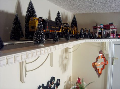 Pics of my husband's train room. Train Around Ceiling, Christmas Train Set Display, Train Shelf Around Room, Train Around Room, Train Display Ideas, Ceiling Train, Train Shelf, Train Room Decor, Train Bedroom