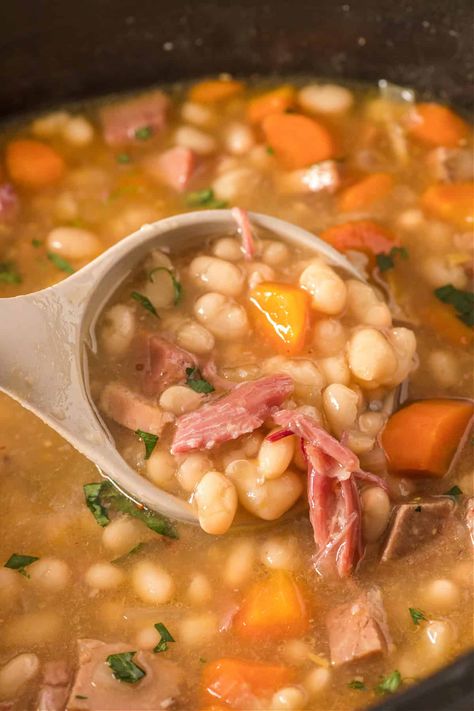 Learn how to make a delicious and hearty crockpot ham and bean soup with this easy recipe. You'll dive into a bowl of homemade goodness with this perfect comfort food for a cozy night in. An easy slow cooker soup recipe and great use of leftover ham. Slow Cooker Navy Bean Soup, Crockpot Ham Bone Soup, Navy Bean Soup Crockpot, Ham Hocks And Beans In Crockpot, Crockpot Ham And Bean Soup, Bean Soup Crockpot, Ham Bean Soup, Crockpot Ham And Beans, Broiled Salmon Recipes