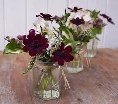 wedding jam jar flowers Jam Jar Flowers, Autumn Wedding Flowers, Mason Jar Flower Arrangements, Deep Red Wedding, Christmas Wedding Flowers, Jar Flowers, Chocolate Cosmos, Red Wedding Flowers, Jam Jars