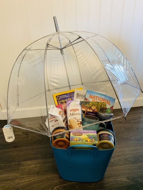 Volunteered to make a “basket” for a silent auction fundraiser. I decided on a “Peaceful Rainy Day” theme. Ended up getting a cool clear bubble umbrella, three different magazines on different subjects (meditation and mindfulness, science and stargazing, and the US National Parks), a Calvin and Hobbes comic anthology, Cadbury hot coco mix, a mug, Pepperidge farms cookies, a snoopy 100 piece puzzle, lemon lavender tea, a nice mellow scented candle, and two different Campbell’s slow cooker soups! Rainy Day Raffle Basket, Rainy Day Basket Auction, Umbrella Gift Basket, Rainy Day Auction Basket Ideas, Cheap Silent Auction Basket Ideas, Rainy Day Gift Basket, Rainy Day Gift Basket Ideas, Rainy Day Basket, Gift Basket Ideas For Adults