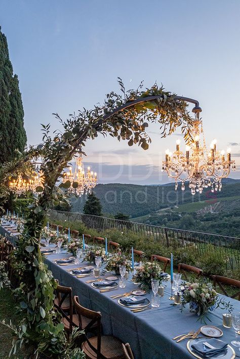 Crystal Chandeliers on Arch supports. Perfect for long tables! #weddingmusicandlights #weddingdecorationidea #weddinglighting Outside Chandelier Wedding, Arch Over Table Wedding, Arch With Chandelier Wedding, Chandelier Arch Wedding, Arched Chandelier Wedding, Over Table Arch, Arch Chandelier Wedding, Chandelier Over Table Wedding, Chandeliers Wedding Decor