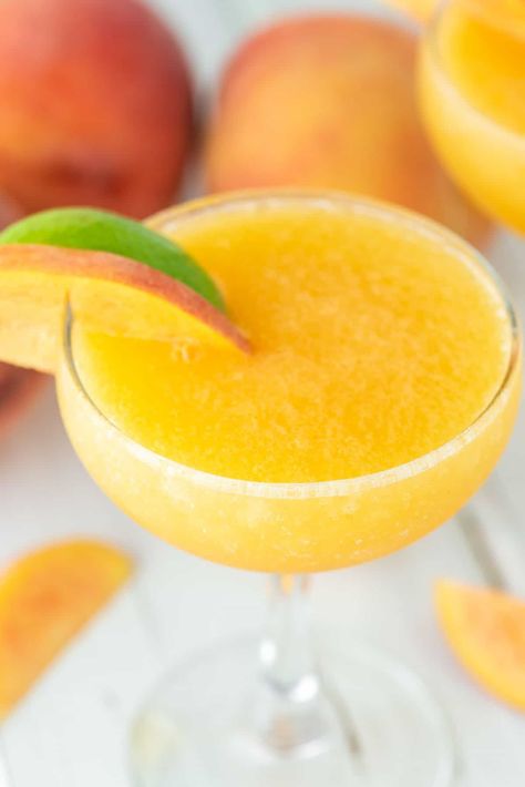 With fresh peaches, rum, maple syrup and lime juice, this peach daiquiri is the perfect fruity summer cocktail. #peachdaiquiri #peachcocktail #daiquiri | chiselandfork.com Frozen Peach Margarita, Fresh Drink Recipes, Peach Margaritas, Fruity Summer Cocktails, Peach Rum, Donut Peach, Passion Fruit Margarita, Fruit Margarita, Peach Daiquiri