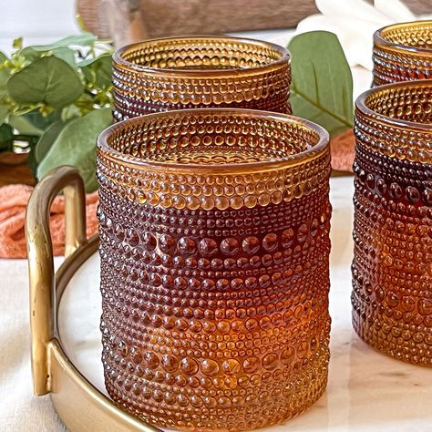 Buy the Kate Aspen® 10oz. Textured Beaded Glass Set at Michaels. com. They have a vibe all their own with the cool embossed glass design and the on trend Amber color. Our 10 oz. Textured Beaded Drinking Glasses are mesmerizing! The embossed glass design and the color make your drinks come alive, you are sure to feel like you are drinking from a piece of art. These beautiful glasses are lead free and dishwasher safe. They are perfect for your favorite holiday cocktails or baby shower mocktails. T Drinking Glasses Set, Diy Wine Glasses, Drinking Glass Sets, Make A Table, Vintage Texture, Diy Wine, Stemless Wine Glasses, Newlywed Gifts, Glassware Set