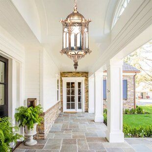 This chandelier uses a classic cage design, and its simple retro look adds to its beauty. Not only can it be illuminated, but it is also a beautiful decoration. | Bloomsbury Market Adelpho Unique Geometric Pendant Glass in Brown, Size 31.89 H x 6.3 W x 6.3 D in | Wayfair Hanging Lantern Lights, Garden Wall Lights, Outdoor Pendant Lights, Hanging Pendant Lamp, Outdoor Lighting Landscape, Outdoor Pendant Lighting, Outdoor Pendant, Outdoor Hanging Lights, Wall Lantern