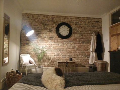 Bare brick feature wall with statement clock. Sleeping dog not part of decor. Bedroom Brick Wall, Uni Bedroom, Brick Wall Ideas, Fake Brick, Brick Feature Wall, Brick Room, Glass Light Fixtures, Wooden Cladding, Industrial Style Decor