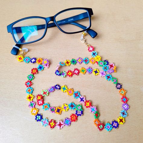 This unique eyeglass chain is meticulously hand-woven from the highest quality glass seed beads, the cute glasses chain you can wear all season long, the boho glasses chain is guaranteed to receive all the compliments. Lenght 80 cm inches 31,5 in                                                                                                                                                  The perfect womens sunglass strap is guaranteed to receive all compliments and your glasses will never be lo Glasses Strap Beads, Beaded Sunglasses Chain, Knitting Bracelet, Boho Glasses, Eyeglasses Chains, Unique Eyeglasses, Sunglass Strap, Colorful Glasses, Glasses Necklace