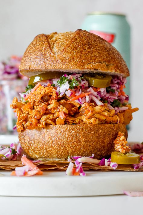 These BBQ Pulled Tofu Sandwiches with Creamy Kohlrabi Slaw are the ultimate summer sandwich! Saucy "pulled" tofu imitates chicken or pork remarkably well, and it's piled high on buns along with a light and creamy kohlrabi cabbage carrot slaw for an amazing summer meal that will elicit two thumbs up from vegetarians and omnivores alike. Cabbage Carrot Slaw, Vegan Pulled Pork Sandwich, Kohlrabi Slaw, Vegan Pulled Pork, Tofu Burger, Cabbage Carrot, Tofu Sandwich, Vegetarian Bbq, Carrot Slaw