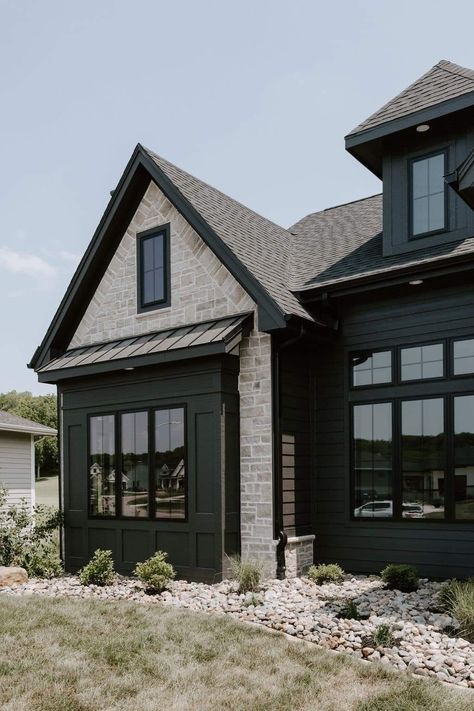 Black House With Light Stone, Black Board And Batten Exterior With Brick, Black And Rock House Exterior, Charcoal And Brick Exterior, Black House Light Stone, Black Siding With Stone, Black Metal Exterior House, Big Windows Front Of House, Dark Grey Siding Black Windows