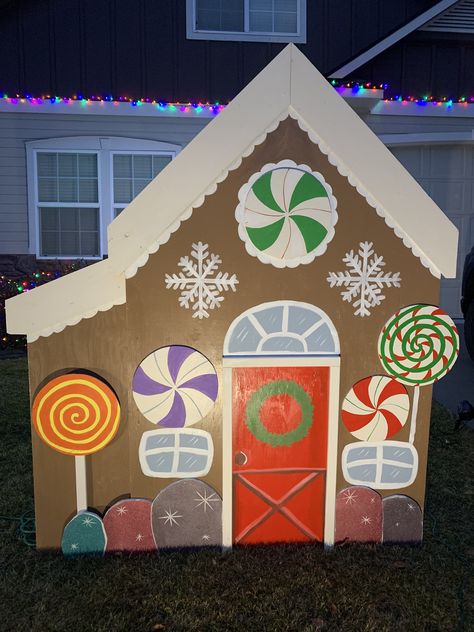 DIY Gingerbread house created from plywood. Diy Gingerbread House Cardboard, Diy Gingerbread House Outdoor, Plywood Gingerbread House, Gingerbread House Wood Cutout, Gingerbread House Frosting, Paper Flower Bouquet Diy, School Hallway Decorations, Cardboard Gingerbread House, Gingerbread Diy