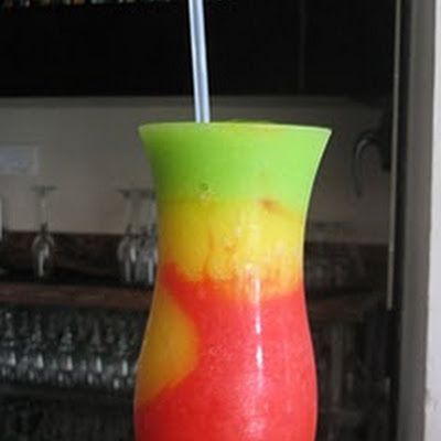 First, start by making the red portion of the drink by combining 1 ounce light rum, 4 ounces strawberry daiquiri mix and 1 cup of ice in a blender. Summertime Cocktails, Strawberry Daiquiri Mix, Cocktail Fruit, Frozen Drink, Sour Mix, Light Rum, Strawberry Daiquiri, Party Punch, Blue Curacao