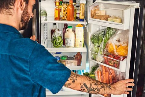 Man opening refrigerator. You can see lettuce, green onions, carrots, and other produce in the door. The rest of the fridge is full of food. Produce Fridge, Store Produce, Smart Fridge, Prevent Food Waste, Fridge Shelves, Fridge Organisers, Fridge Storage, Fridge Door, Organisation Hacks