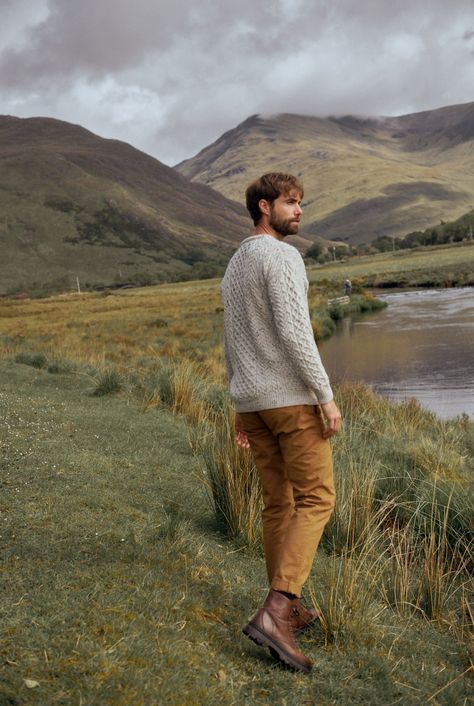 A symbol of Ireland past and present, the Inisheer Traditional Aran Sweater is a timeless addition to your wardrobe. Made with 100% Merino wool, the quality of this authentic Irish gem cannot be rivalled, its is a true Irish hero Aran piece. Much like its namesake, the Inisheer Aran Sweater captures the essence of Ireland in all of its glory. With a beautiful combination of traditional Aran stitches such as honeycomb, moss and cable, this piece is inspired by the past while remaining firmly root Irish Men Aesthetic, Mens Scotland Outfit, Farm Men Outfit, Outdoor Wear For Men, Men’s Outdoorsy Style, Men Outdoorsy Style, Men In Nature Aesthetic, Irish Style Men, Irish Fashion Mens