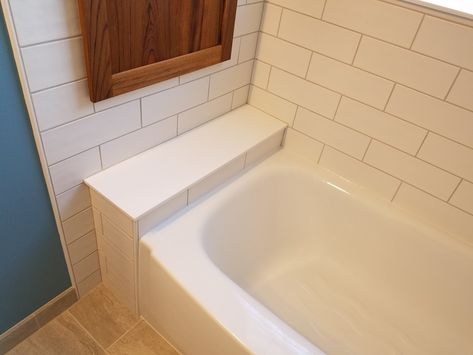 Tub ledge for storage of shampoo bottles Tub Bench, Bath Tub Ledge, Bath Tub With Ledge, Tub Ledge, Bath Tub Tile Surround Shelves, Bathroom Tile Alcove Tub, Bathroom Remodel Alcove Tub, Alcove Tub With Half Wall, Bathtub Bench