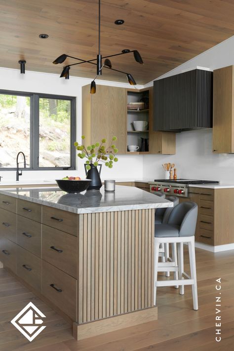 Modern white oak cottage kitchen with an angled white oak slated kitchen island and a custom metal fluted range hood. Fluted Range Hood, Modern White Oak Kitchen, Framed Cabinets, Modern Cottage Kitchen, White Oak Furniture, Kitchen Styling Modern, White Oak Kitchen, Corner Kitchen Cabinet, Modern Renovation