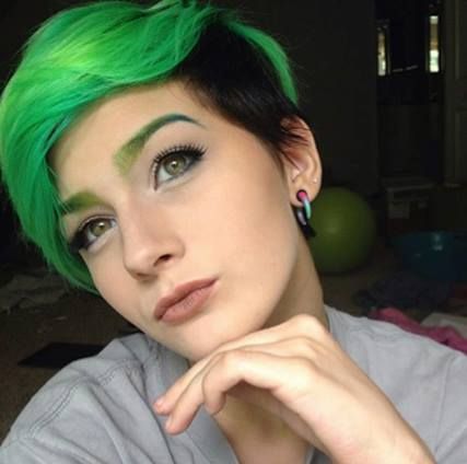 We are loving the whole look of this pretty and pensive pixie. At the same time that she looks colorful and edgy, she's also got an element of classic, timeless beauty. @_hannahhbanana used our Electric Lizard and Atomic Turquoise for the green hair, and to get the black color for the two-tone portion, use our Raven. For a rosy nude lip like this, try our Lethal Lipstick in Naked Under Leather. Colored Eyebrows, Pixie Color, Short Scene Hair, Hair Dyed, Cute Hair Colors, Boring Hair, Pixie Hair, Fantasy Hair, Hair Tattoos