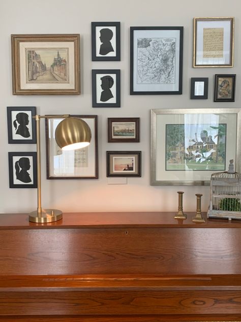 These silhouettes make a perfect addition to this gallery wall above our piano. Over Piano Wall Decor, Gallery Wall Above Piano, Above Piano Wall Decor, Above Piano Decor, Piano Shelf, Dark Green Living Room, Piano Wall, Office Redo, Wall Layout