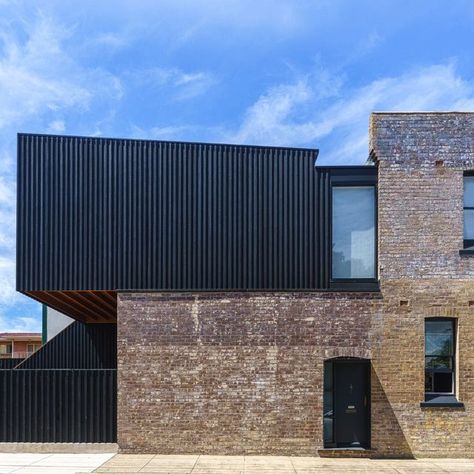 Abodo Wood on Instagram: "In Sydney's Inner West, a corner store dating back to c.1900 has gone through a sympathetic and respectful renovation to now serve as the studio space for @kreisgrennanarchitecture, complete with an upstairs apartment. A rear upper level extension in Vulcan board and batten cladding is starkly contrasted against the faded terracotta tones of the historic brick. Protector Nero's dark finish and the black accents on the original building help to visually connect the two Board And Batten Cladding, Faded Terracotta, Upstairs Apartment, Black Cladding, Timber Battens, Timber Architecture, Glazed Brick, Brown Brick, Ocean Grove