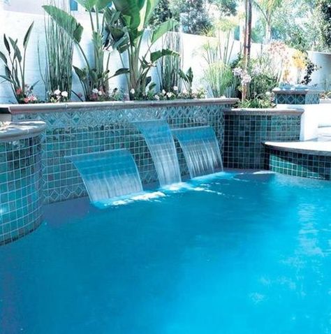 These small waterfalls come right out of the tile and have a fashionable look, especially with the mirrored tile. They're also three different sizes and heights so you can enjoy them. Swimming Pool Waterfall, Dream Backyard Pool, Pool Water Features, Swimming Pool Tiles, Pool Remodel, Pool Landscape Design, Pool Fountain, Waterfalls Backyard, Swimming Pool Water