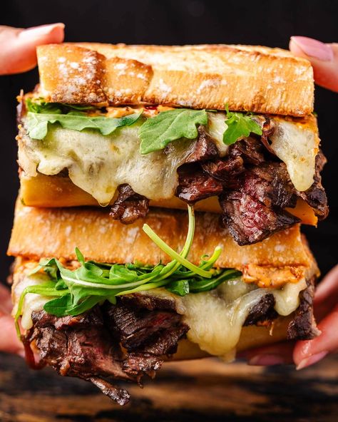 The best steak sandwich combines a perfectly toasted baguette that's piled with sliced skirt steak, caramelized onions, melted provolone, baby greens, and the easiest chipotle mayo. This sandwich is truly impossible to resist! #steaksandwich #steak #sandwiches Steak Sandwich Brioche, Sourdough Steak Sandwich, Steak Panini Sandwiches, Skirt Steak Sandwich Recipes, Flank Steak Sandwich Recipes, Steak Sandwich Sides, Sirloin Steak Sandwich Recipes, Shaved Steak Sandwich Recipes, Steak Sandwich Marinade