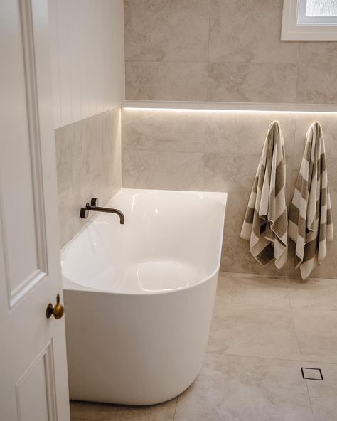 How incredible is this bathroom space by @NavyBoxConstructions?! Achieving the spa like feeling with the Posh Solus back-to-corner bath paired with the timeless white shaker style Kado Lux vanity. Contrasted by the Milli Pure tapware in brushed gunmetal with beige, textured tiles for a bright and inviting bathroom. 

Reece featured products 🛁 :
Milli Pure tapware, Milli Mood shower, Kado Lux vanity, Posh Solus back-to-corner freestanding bath. Bathroom Gunmetal Tapware, Brushed Gunmetal Bathroom, Light Beige Bathroom, White Beige Bathroom, White And Beige Bathroom, Hamptons Bathroom Ideas, Beige Bathroom Tile, Gunmetal Tapware, Beige Tile Bathroom