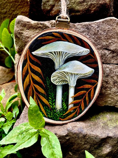 Original, one of a kind, hand painted artwork on wood slice. This miniature painting is perfect for small places or as an ornament. Comes with antique brass finish hanging hardware and a loop of natural jute twine.  Shipping included. Circle Wood Painting Ideas, Wood Mushrooms, Wood Slice Painting, Mushroom Painting, Mushroom Paint, Painted Ornament, Wood Slice Art, Wood Painting Art, Painted Artwork